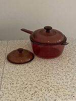 Saucepan with matching lid and extra smaller lid displayed