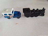Blue glass mail truck and black locomotive decanters