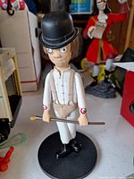 Front view of Alex DeLarge figure showing attire, cane, base