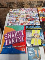 Shows collage puzzle, Smarty Party, KidzLabs Human Torso Anatomy, Dad Jokes book