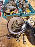 Two plastic bins filled with various keys, padlocks visible