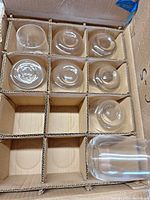 Divided 12-slot box with several short tumblers inside