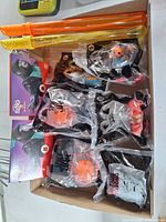 Box containing sealed McDonald's Happy Meal toys and two bubble wands