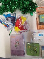 Overview of garland, balloons, foam shapes, craft kit and other sealed items