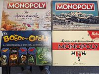Front view of all four Monopoly game boxes