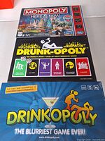 Fronts of Monopoly Here & Now, Drunk-Opoly, Drinkopoly boxes
