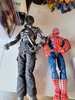 Snake Eyes and Spider-Man figures side by side showing scale and condition