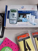 Boxed SmartShopper organizer with two packs of Cole stencils and partial notebooks