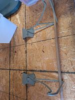 metal hanger disassembled showing mounts, arms, and wooden dowel