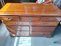 Front view of Pennsylvania House wooden dresser showing eight drawers and brass bail pulls