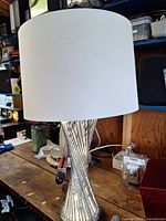 Full view of lamp showing shade and lit mirrored base