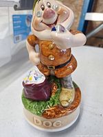 Full view of Doc figurine on base showing colours, pose and gem bag