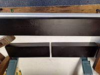 Top view of shelves showing one long and two short black shelves