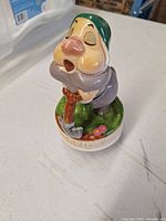 Front angled view of ceramic Sleepy dwarf music box on table