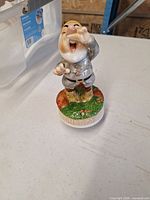 Full view of Sneezy music box standing on table