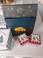 Group shot of large holly scroll box, candle box, two gingerbread boxes