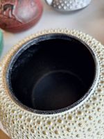 Interior of ivory hobnail teapot showing enamel lining