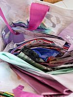 Bag filled with folded gift bags, tissue and wrap