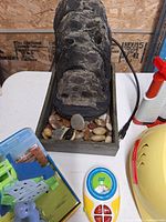 Fountain, toy items, part of net and helmet visible