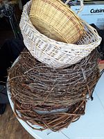 stack of grapevine wreaths with two wicker baskets on top