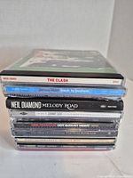 Stack of CDs showing visible spines and titles