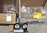 Three boxes containing assorted bulbs and solar light unit