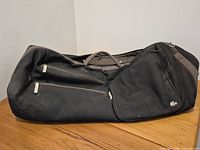 Full view of Lacoste soft rolling duffel lying on side showing overall condition