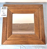 Full view of square wooden framed mirror