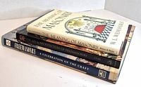 Three stacked Freemasonry books showing spines and cover of top volume