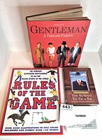 Front covers of three books and Tamron cutlery set