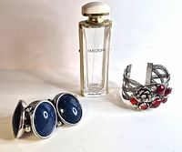 Front view showing both cuff bracelets and Emozione perfume bottle