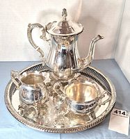 Complete four-piece silverplated service on tray
