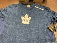 Front view showing logo, tags, and fabric pattern