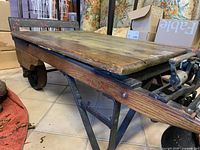 Full view of cart showing wood top, metal frame, wheels