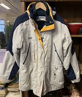 Front view of Columbia hooded parka on hanger displaying overall color scheme and pocket layout