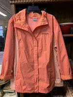 Front view of coral Columbia hooded rain jacket