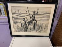 Framed artwork showing full composition with two riders and windmills