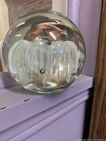 clear spherical paperweight with white internal tendril design