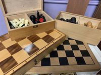 Overall view of two boards and two wooden boxes of pieces