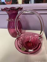 Cranberry glass vase and basket bowl together showing size, shape, color