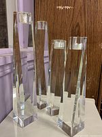 Four faceted crystal candleholders standing together