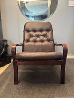 Front view of lounge chair showing leather cushions and bentwood arms