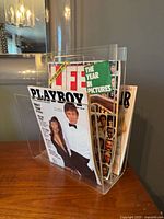 Holder filled with magazines showing capacity and transparency