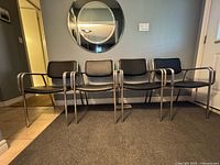 Front view of four matching chrome tubular chairs