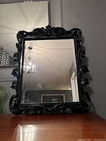 Front view of ornate framed mirror showing full frame and beveled glass