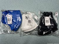 Blue, white, black Adidas face covers sealed in plastic