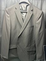 Front view of black blazer on hanger