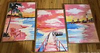 Three framed canvas prints laid out showing beach scenes