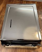 front view of chrome paper towel dispenser showing polished finish and towel level slot