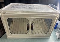 Front view of storage box with twin doors and chrome handles